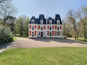 a large white house with a gambrel roof at Château des Fougères Trouville sur Mer in Trouville-sur-Mer