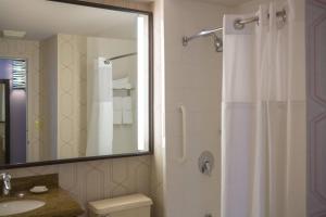 a bathroom with a shower and a toilet and a sink at Courtyard by Marriott New York Manhattan/ Fifth Avenue in New York +16 photos