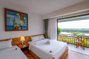 Postel nebo postele na pokoji v ubytování Palm Riverside Boutique