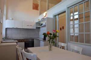 a kitchen with a table with a vase of flowers on it at Al Castello di Aiello in Aiello del Friuli