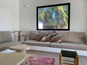 a living room with a couch with a window at Modern villa in Lajares with private pool in La Oliva