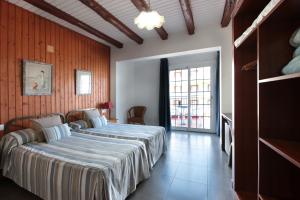 a bedroom with a large bed in a room at Hotel Marblau Tossa in Tossa de Mar