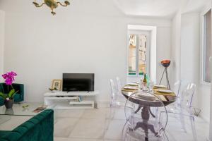 a living room with a glass table and a tv at Madonuccia - Hypercentral Chic & Cosy - by TGB in Ajaccio