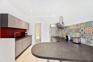 a kitchen with a sink and a counter top at Madonuccia - Hypercentral Chic & Cosy - by TGB in Ajaccio +32 photos