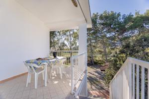a patio with a table and chairs on a balcony at Casa Mulas in Tertenìa +23 photos