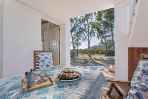 a room with a table with a plate of food on it at Casa Mulas in Tertenìa