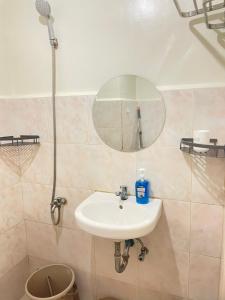 a bathroom with a sink and a mirror at Gin Studio Rent Davao in Davao City