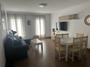 a living room with a table and a dining room at El pasaje Apart in Ronda