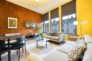 a living room with a couch and a table at Spacious Central Station 2 Bed Apartment B3 in Glasgow