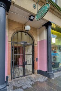 an entrance to a store with a gate on a building at Spacious Central Station 2 Bed Apartment B3 in Glasgow