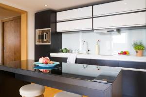 a kitchen with a counter with a bowl of fruit on it at Sun Gardens Dubrovnik in Dubrovnik