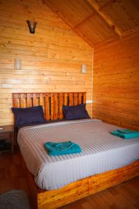 a bedroom with a bed in a wooden cabin at Sameer beachfront Cottages in Canacona