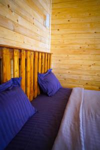 a bedroom with a bed in a wooden cabin at Sameer beachfront Cottages in Canacona