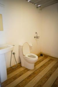a bathroom with a toilet and a sink at Sameer beachfront Cottages in Canacona