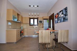 a kitchen with a table and chairs in it at Villa Selene in Alonnisos Old Town