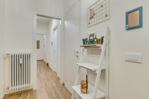 a room with white walls and a white staircase at Rooms Vidar Train Station in Marghera