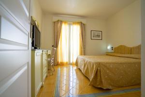 Postel nebo postele na pokoji v ubytování Hotel Santa Caterina