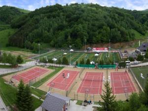 an aerial view of two tennis courts on a hill at ApartHotel Kopaonik in Brzeće