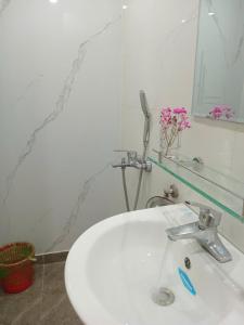 a bathroom sink with a toothbrush and a mirror at Luna House in Hanoi +26 photos