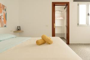 a bedroom with a bed with a yellow towel on it at Bonito apartamento en Ingenio in Ingenio