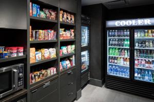 a grocery store aisle with a refrigerator and drinks at Courtyard by Marriott Houston Heights/I-10 in Houston