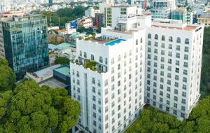 an aerial view of a tall white building at T-Ritz Saigon Hotel & Apartment in Ho Chi Minh City