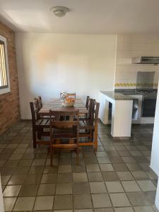 ein Esszimmer mit Tisch und Stühlen in einer Küche in der Unterkunft Condominio Stoneville in São Sebastião