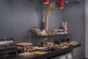 a buffet line with various pastries and other foods at NH Trieste in Trieste