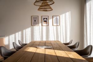 a conference room with a wooden table and chairs at Khiwane Boutique Hotel in Hoedspruit +84 photos