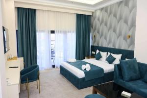 a hotel room with a bed and a couch at Ketrin Hotel Restaurant in Ayntʼapʼ