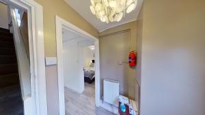 a room with a hallway with a chandelier at Charles House in Chatham +14 photos
