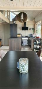 a kitchen with a black table with a bowl on it at Cozy Family Cabin In Uniquely Situated Hiking Area in Indre Standal