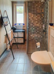 a bathroom with a shower and a table at Cozy Family Cabin In Uniquely Situated Hiking Area in Indre Standal +10 photos