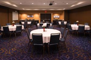 a conference room with tables and chairs with white table cloth at Courtyard by Marriott Hot Springs in Hot Springs