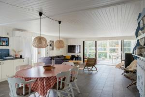 a kitchen and living room with a table and chairs at Magical Atmosphere Close To The Sea in Sæby