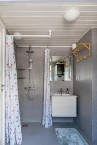 a bathroom with a sink and a shower curtain at Magical Atmosphere Close To The Sea in Sæby +29 photos