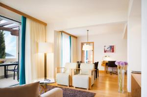 a living room with a table and chairs and a dining room at Sun Gardens Dubrovnik in Dubrovnik