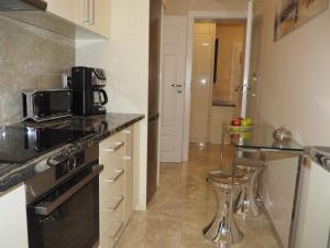 a kitchen with a counter and a sink and a microwave at Grand-Tourist Posejdon Apartments in Gdańsk