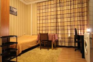 a bedroom with a bed and a table and chairs at Apartment Nadezhda at Kabanbay Batyr 122 in Almaty