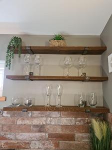 a row of wine glasses sitting on a shelf at The Hide in Ullapool