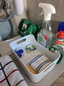 a plastic container with a towel and a bottle of cleaner at The Hide in Ullapool