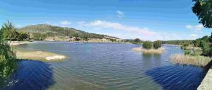 a rendering of a river with a mountain in the background at GuestReady - Countryside atmosphere in Sernancelhe in Fonte Arcada