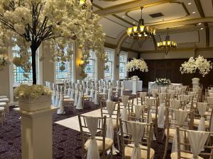 a banquet hall with tables and chairs in a room at The County Hotel Newcastle in Newcastle upon Tyne