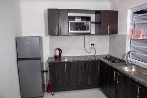 a kitchen with a refrigerator and a microwave at one Bedroom apartment A2 in Cape Town +27 photos