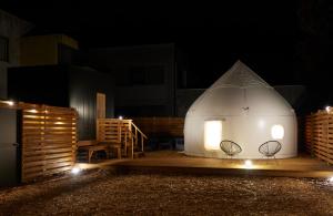 a large dome tent with two chairs in the dark at ReSchool Nasu Glamp in Nasu