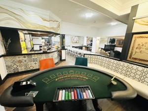 a waiting room with a table with books on it at Entire Venue Hire with 8 Bedroom Accommodation - Your Own Pub Experience in Swansea