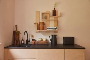 a kitchen with a sink and a counter top at Yarn - Arlo Deluxe Suite in Ballycastle