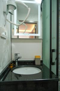 a bathroom counter with a sink and a mirror at mansion yellow hotel in Istanbul