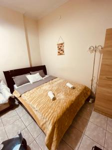 a bedroom with a large bed with two objects on it at Marinos in Kavala