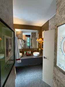 a bathroom with two sinks and a large mirror at Marbella Boutique Art suites in Marbella